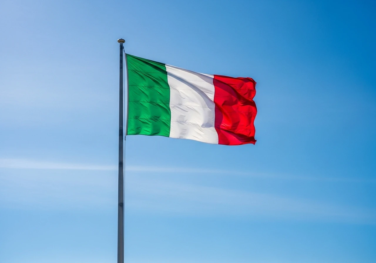 Italian flag waving against a clear blue sky