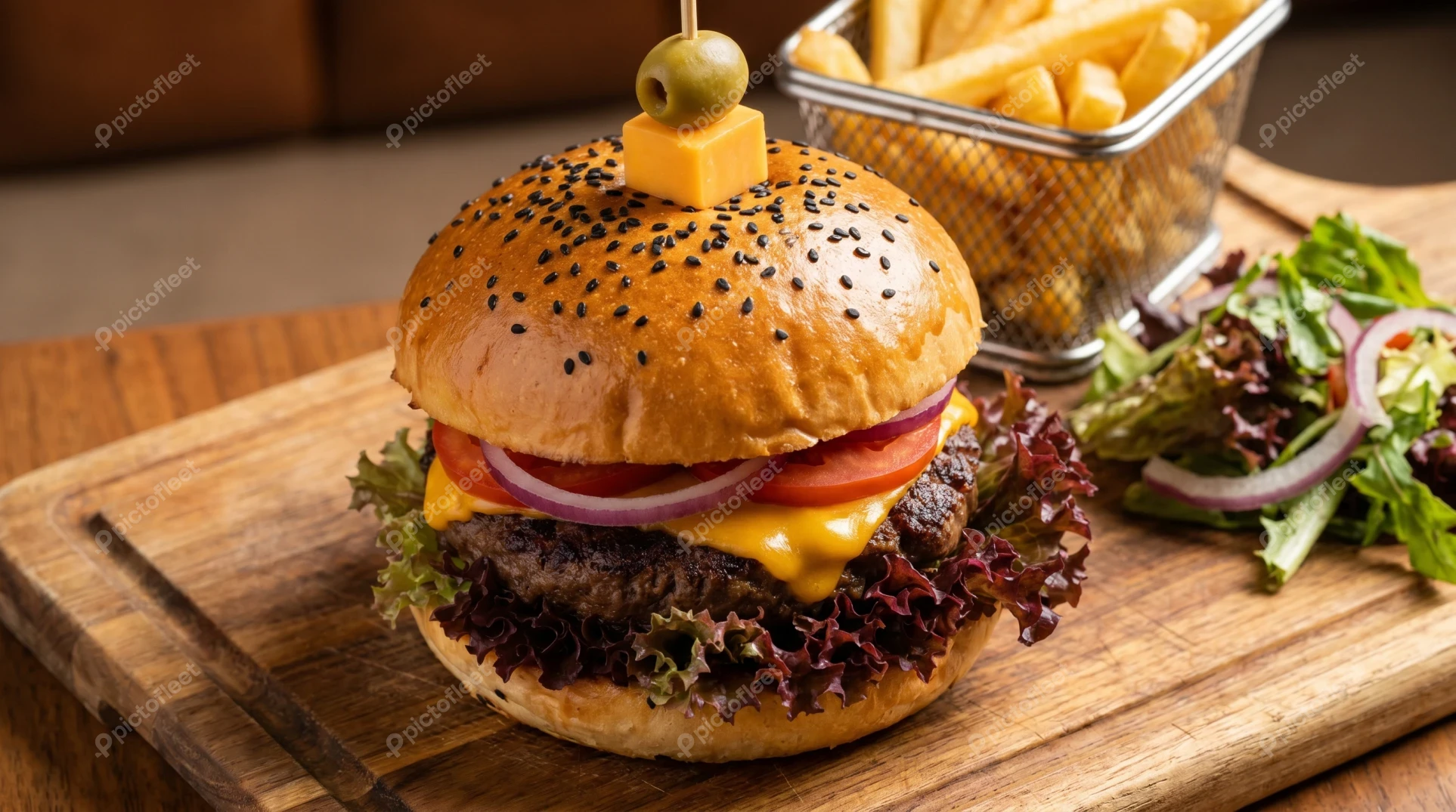 Gourmet beef cheeseburger with french fries and side salad