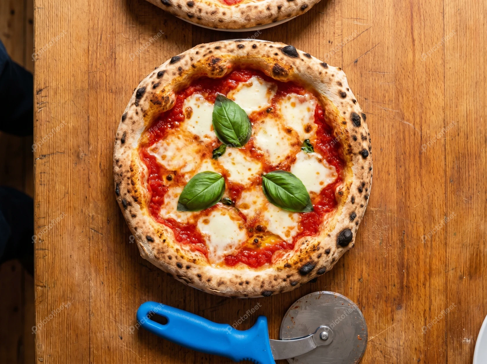 Authentic Italian pizza margherita on a wooden table