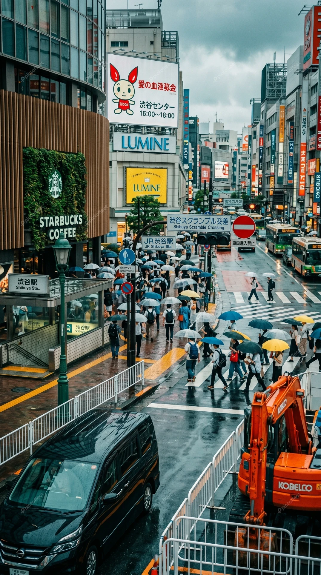Busy Tokyo street scene with pedestrians in the rain