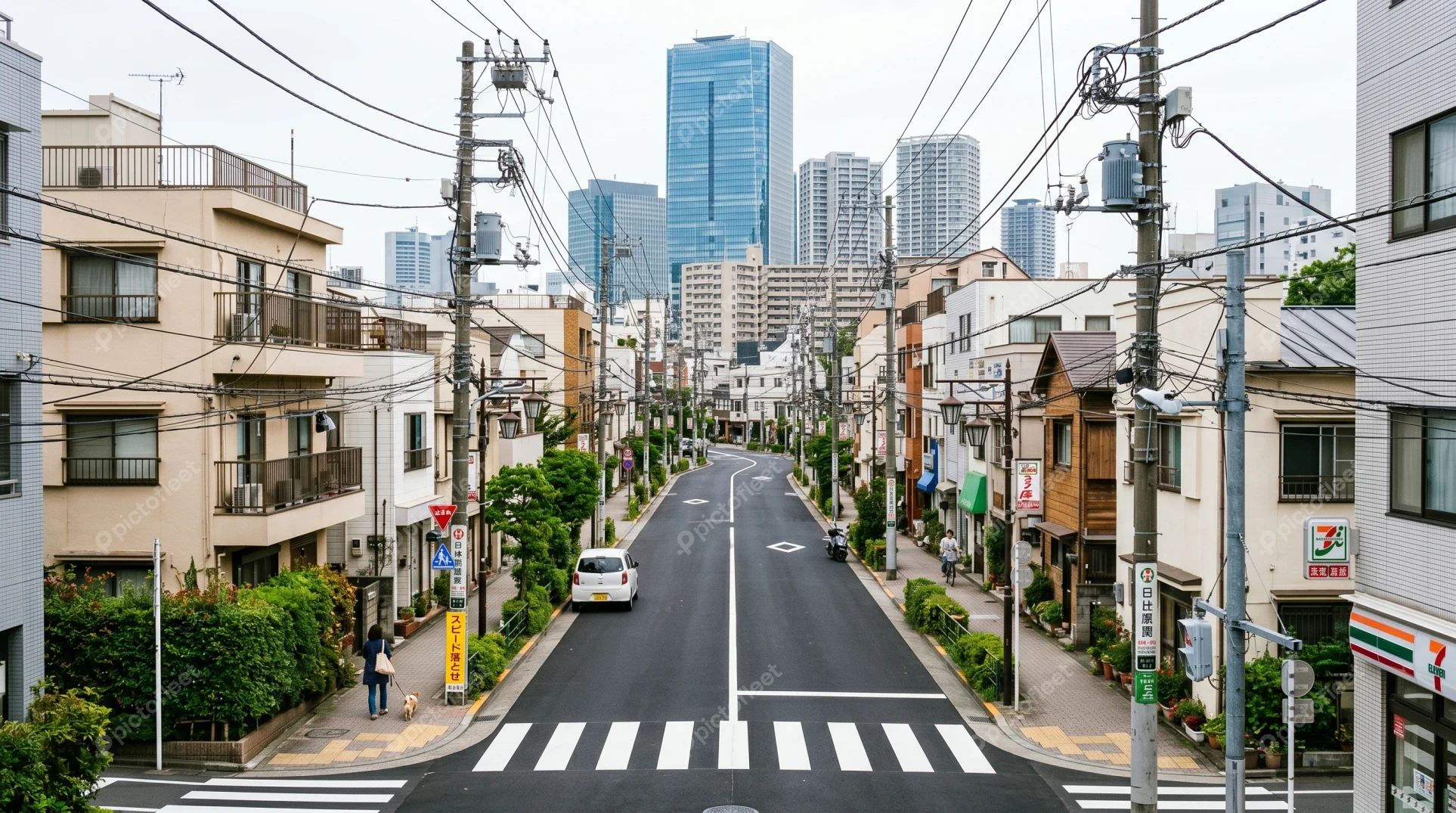 Urban street in Tokyo leading towards modern city skyline