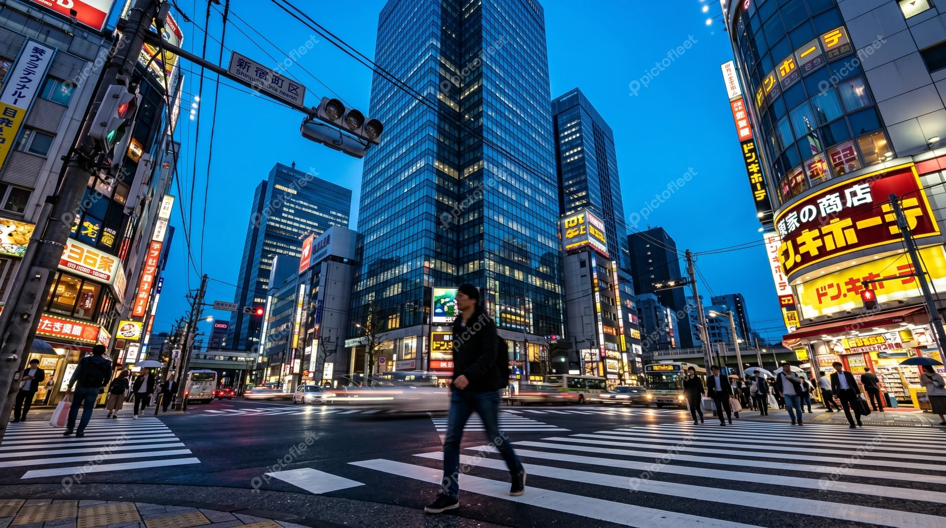 Busy crosswalk in Shinjuku, Tokyo at twilight
