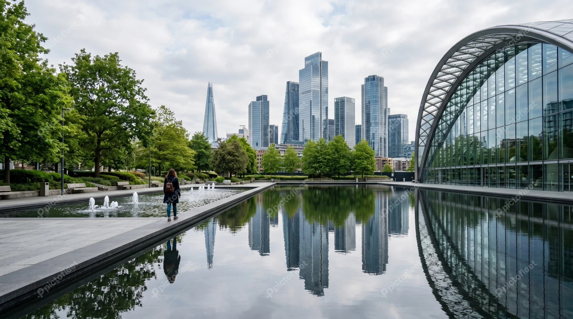 Canary Wharf skyline reflected in urban park water feature