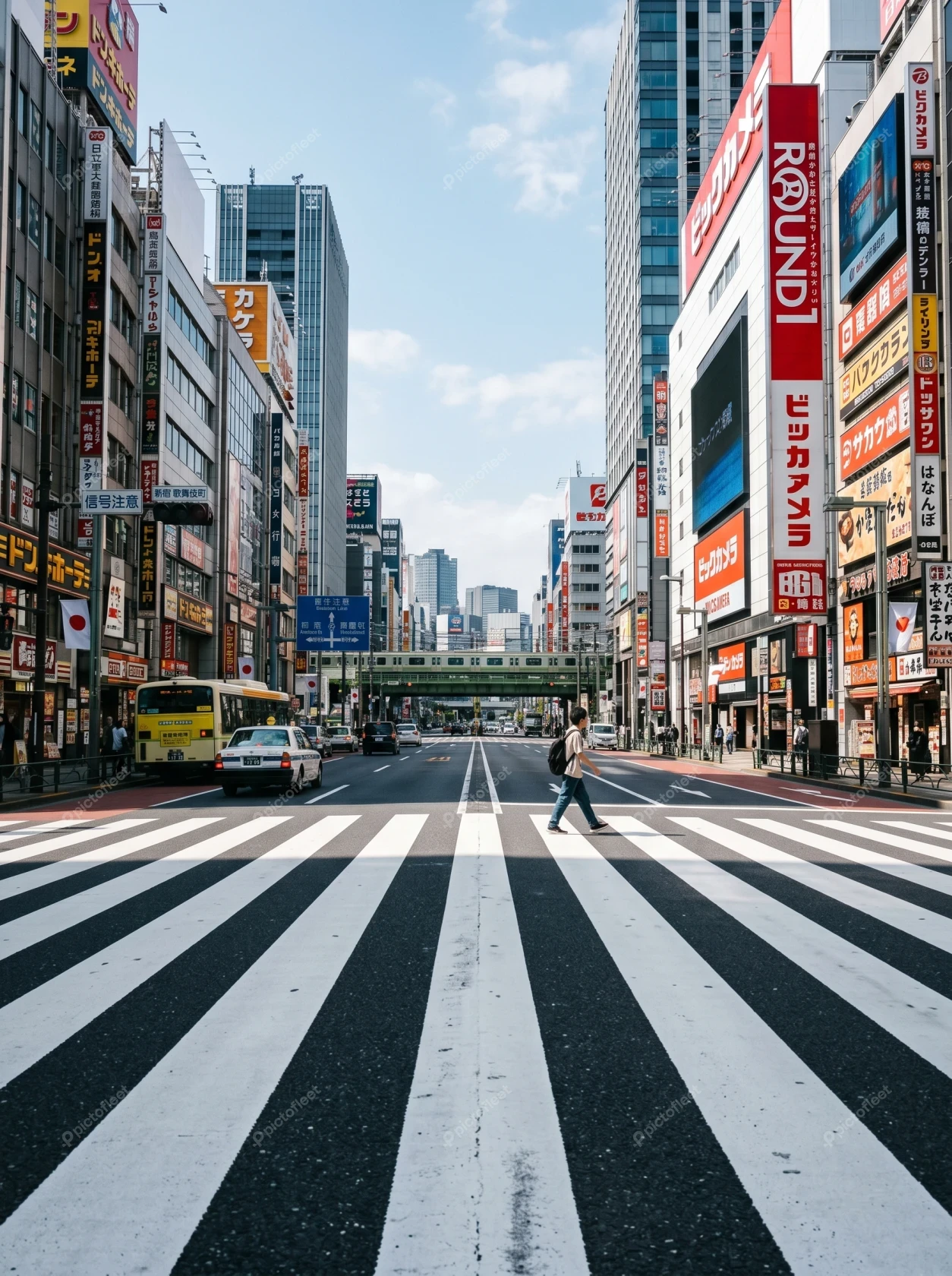 Pedestrian crossing a wide street in Shinjuku Tokyo