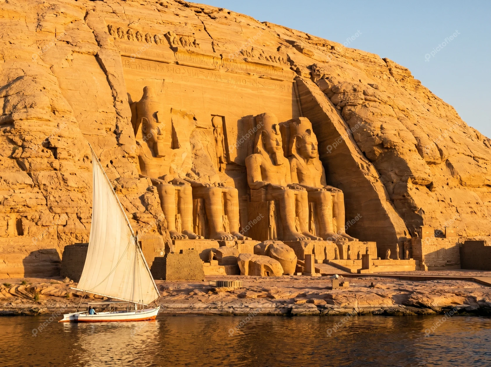 The Great Temple of Abu Simbel and felucca at sunset