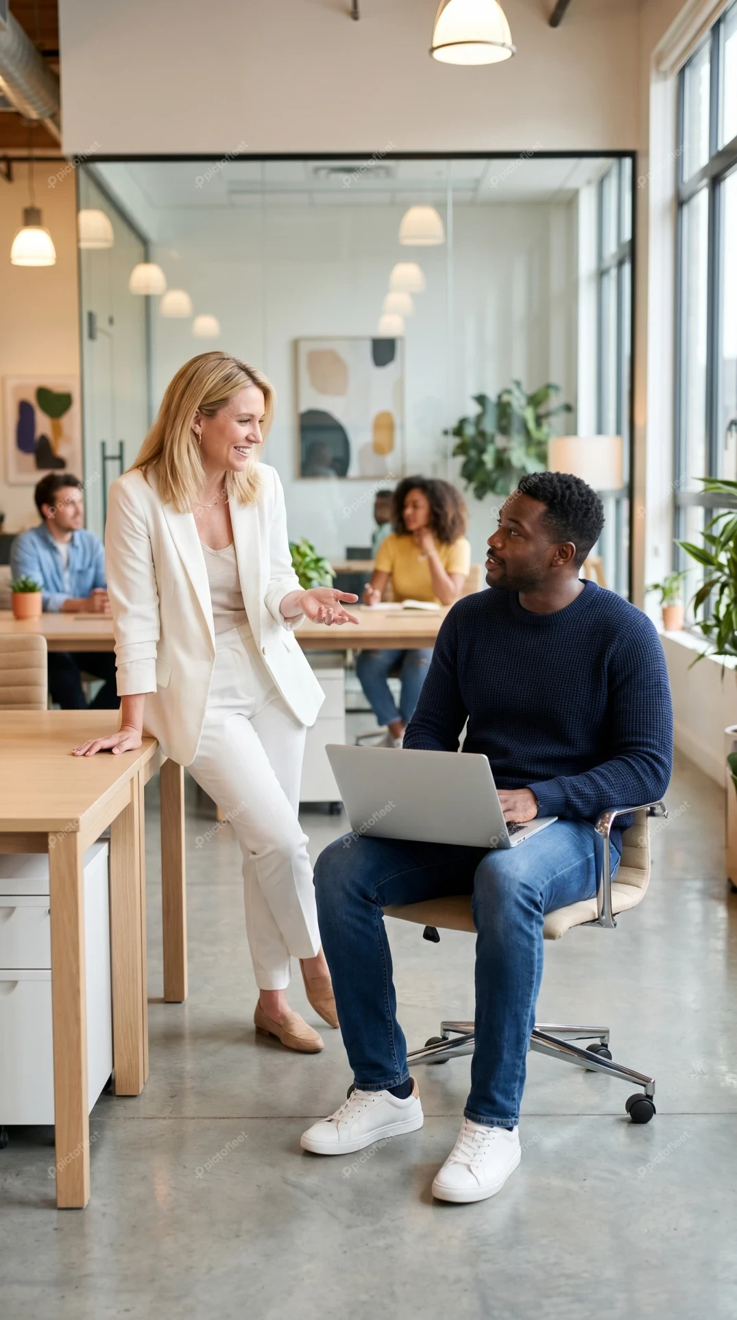 Colleagues collaborating in a bright modern open plan office