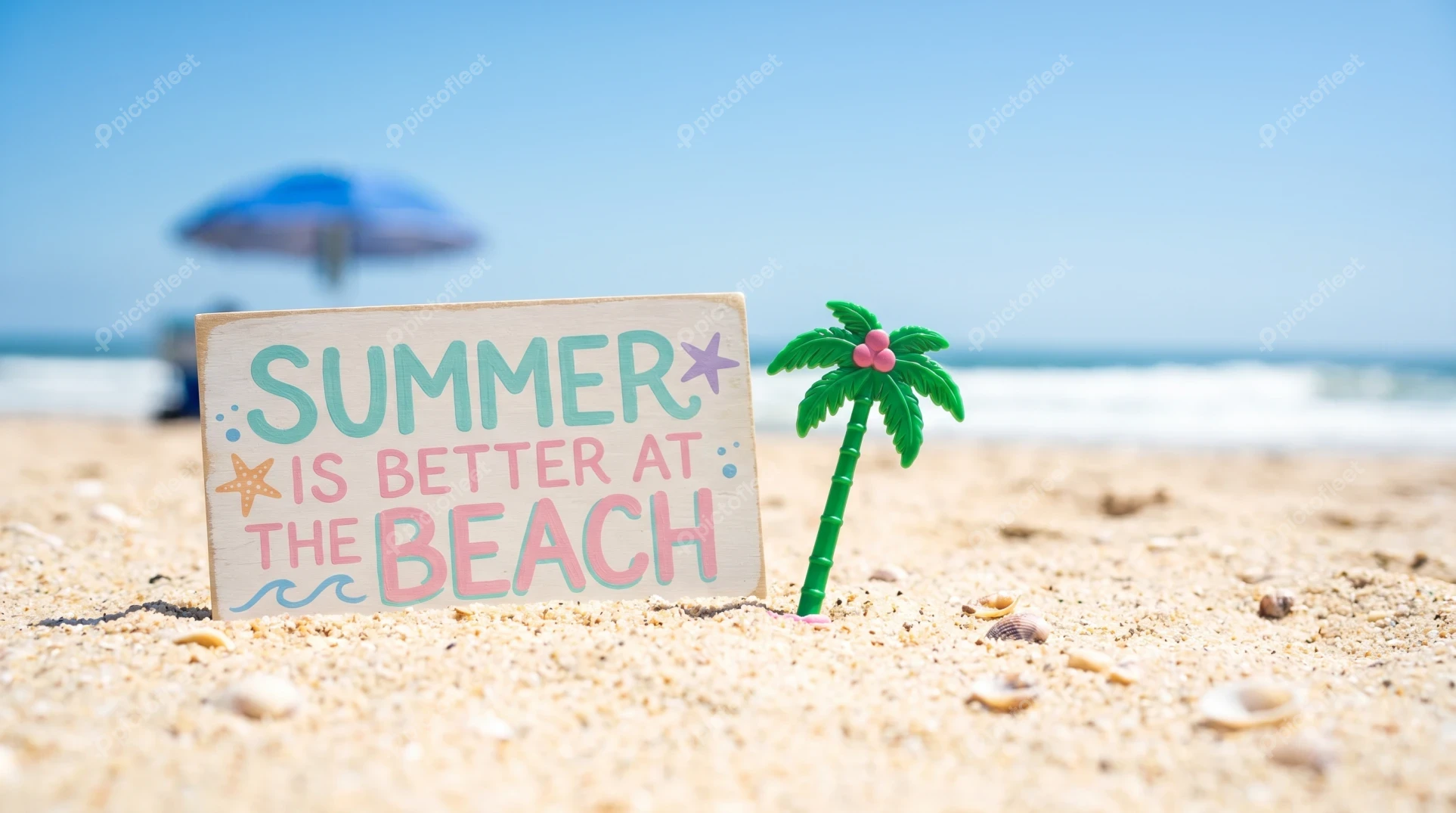 Summer is better at the beach" wooden sign on sand