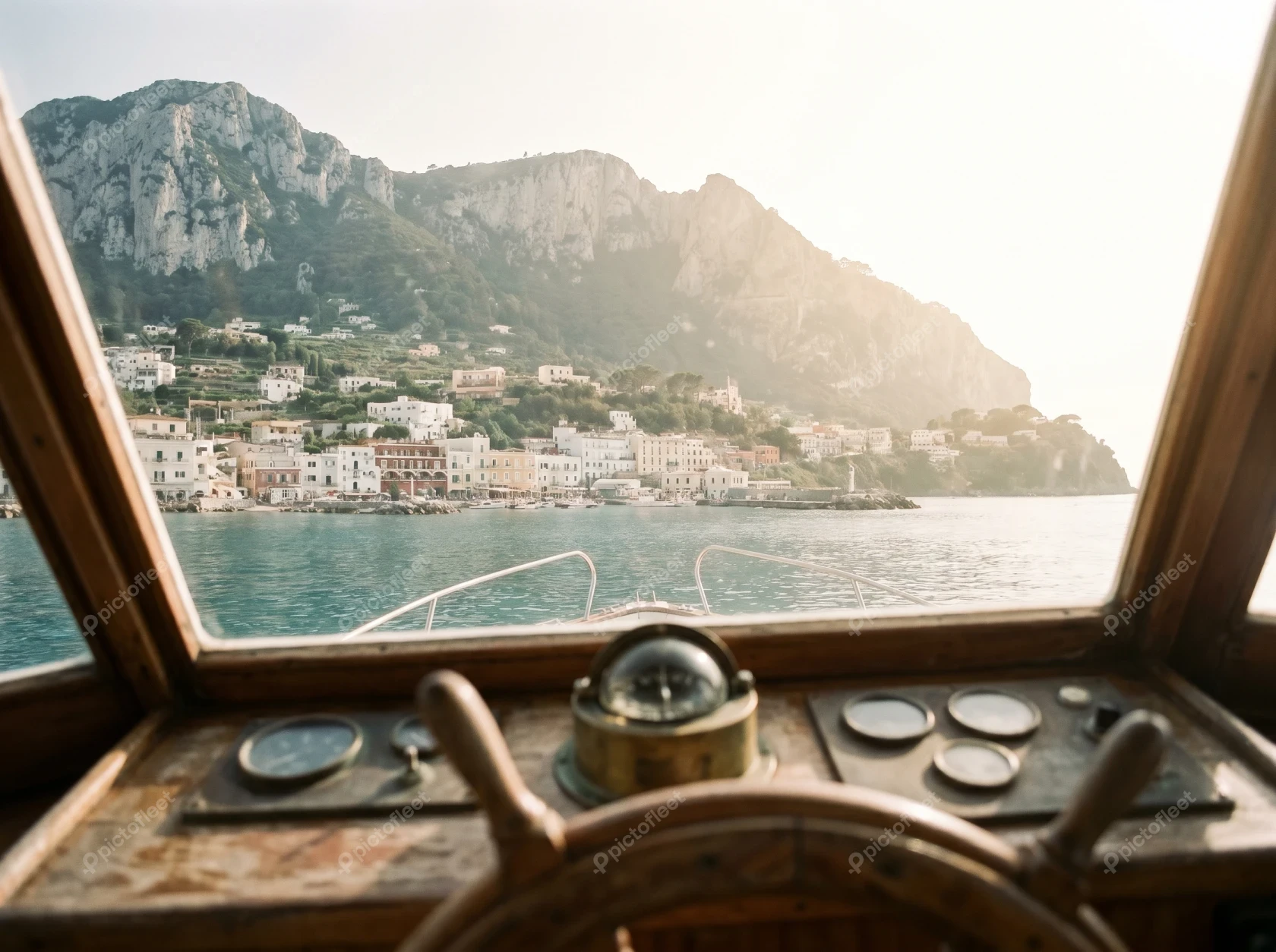 View from a wooden boat cockpit approaching Capri island, Italy