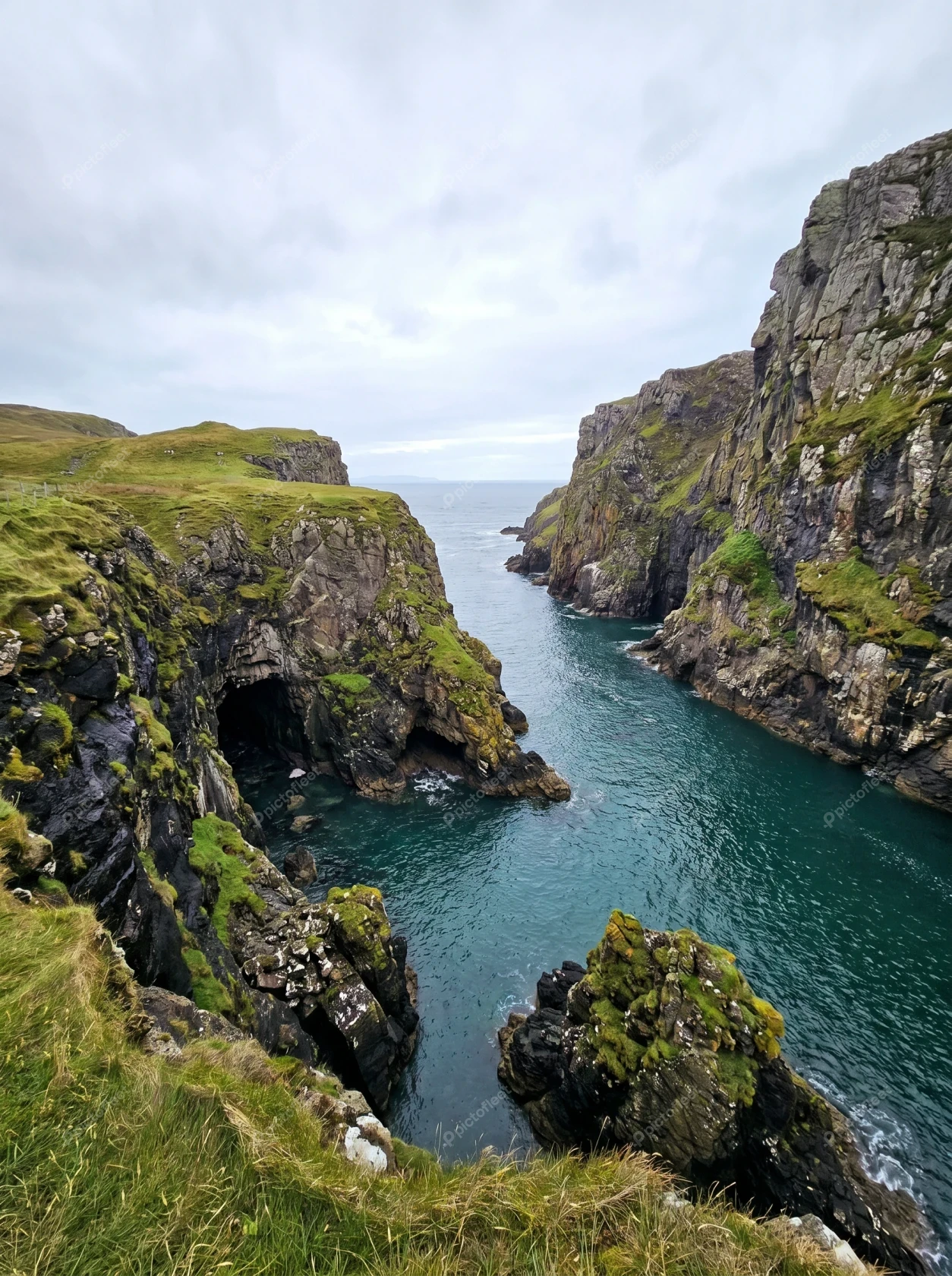 Scenic rocky cliffs and sea inlet on a cloudy day