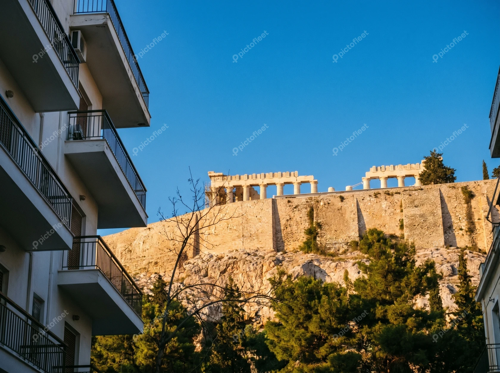 View of the Acropolis in Athens between city apartment balconies
