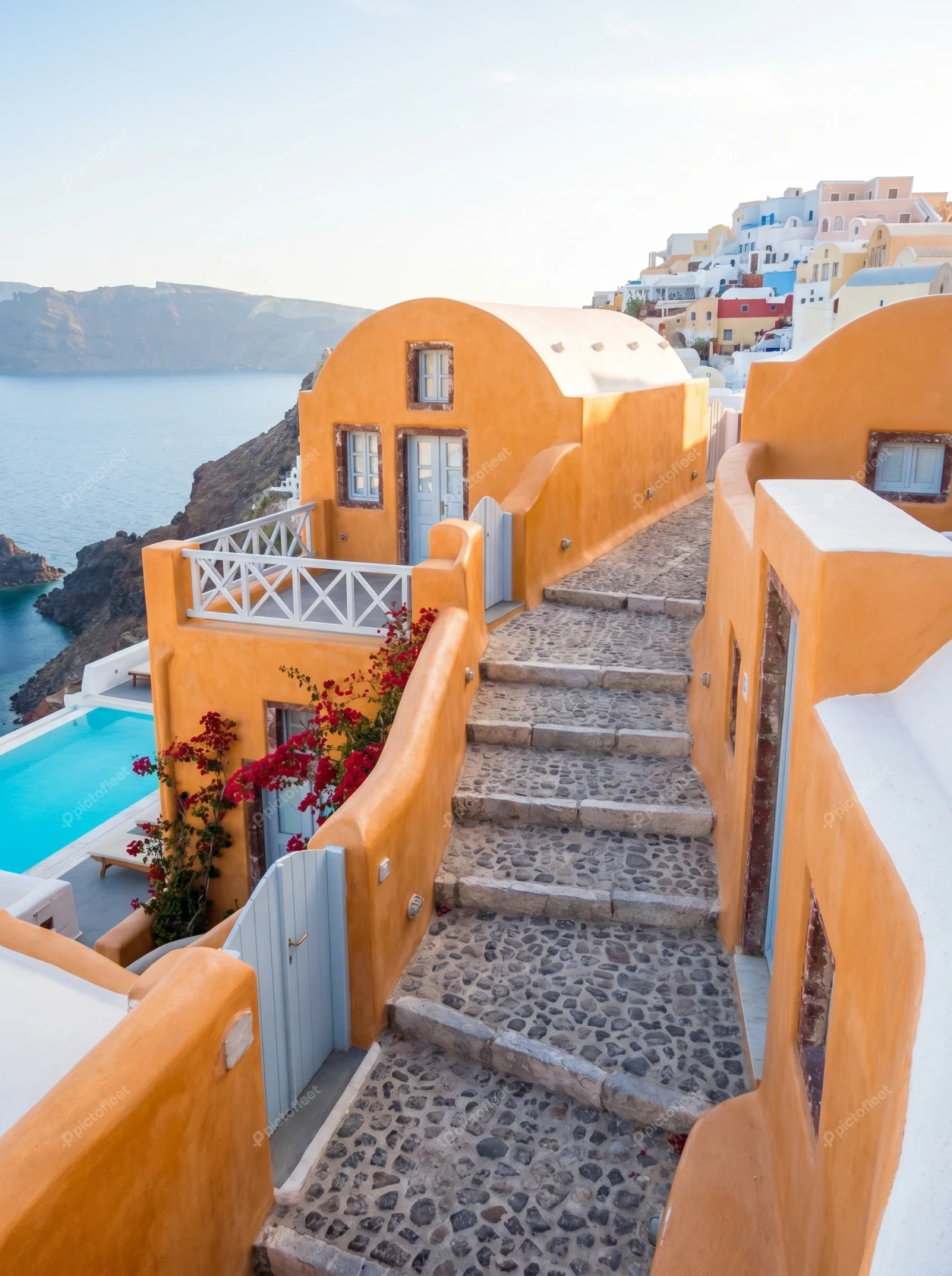 Traditional orange houses on a Santorini hillside overlooking the sea